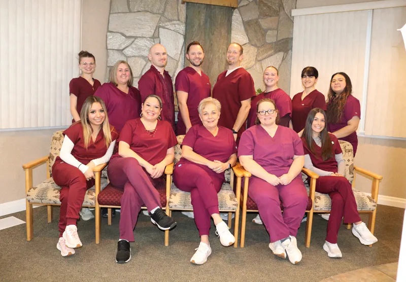 Mirci Dental Team all wearing red scrubs